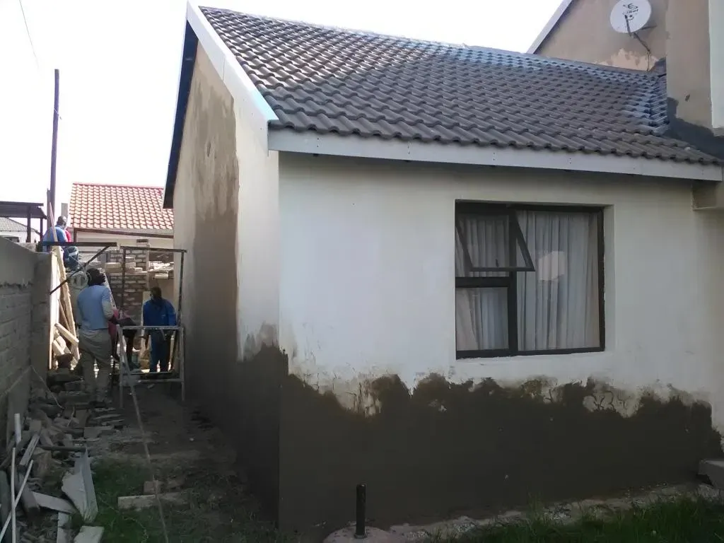 A small house with a satellite dish on the roof