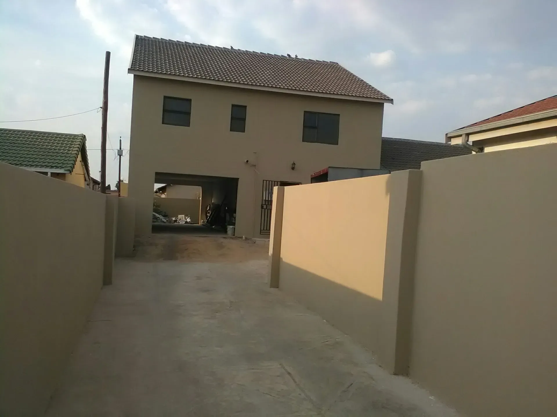 A large house with a driveway leading to it