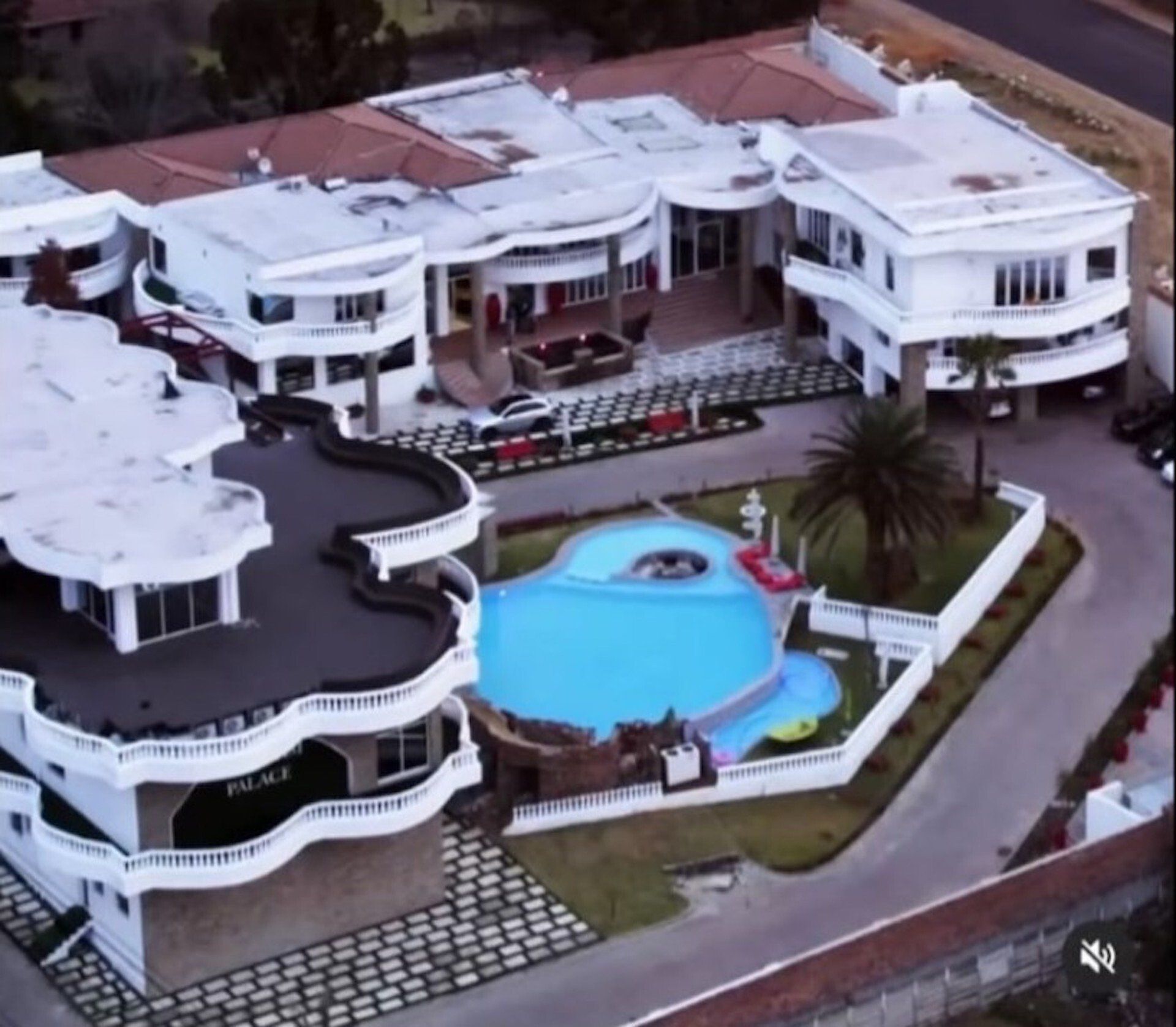 An aerial view of a large house with a swimming pool