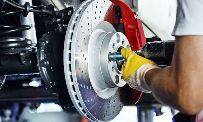 A Person is Fixing a Brake — AEQ - Auto Electrics QLD in Woombye, QLD