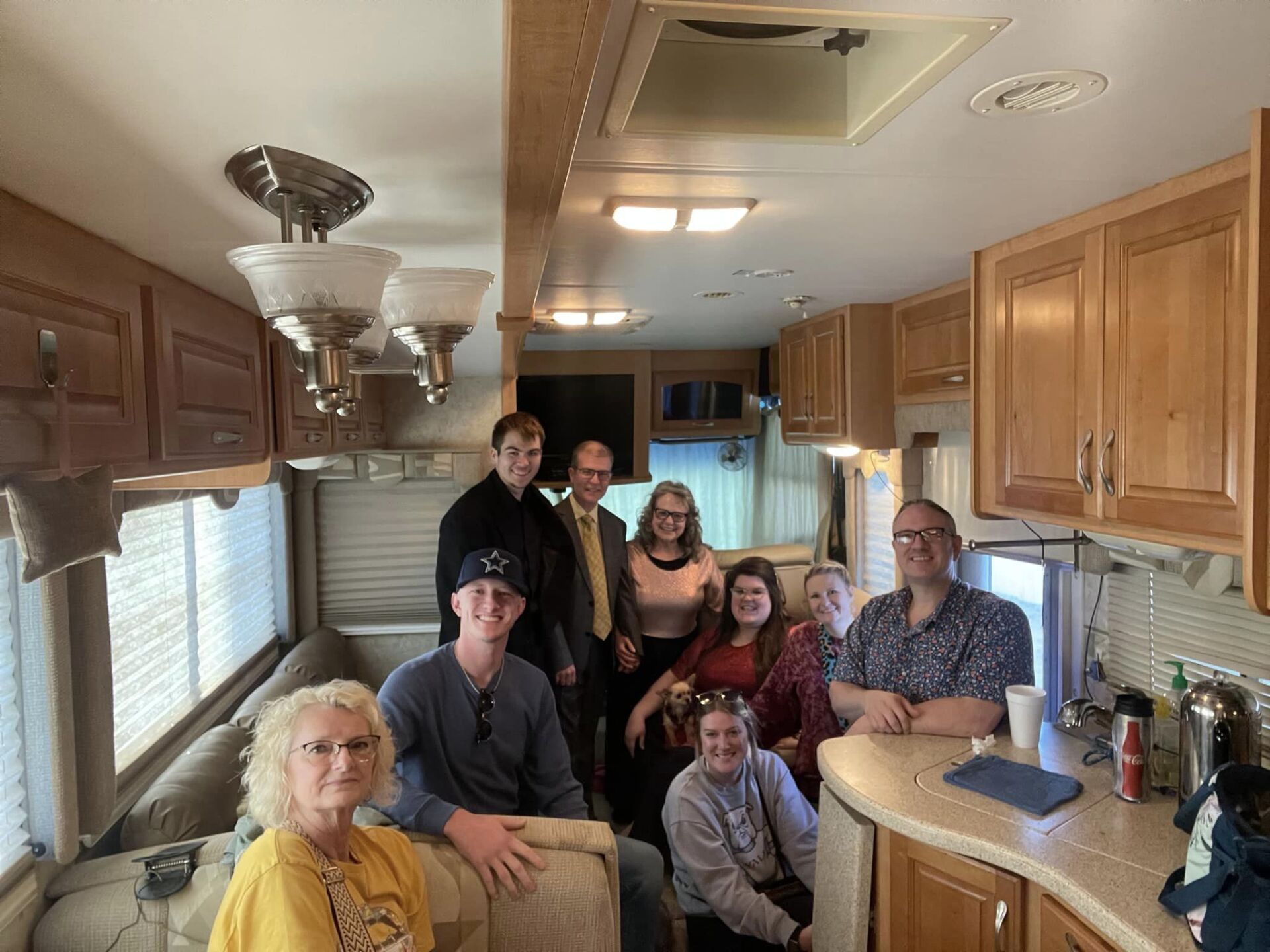 A group of people are posing for a picture in a rv.