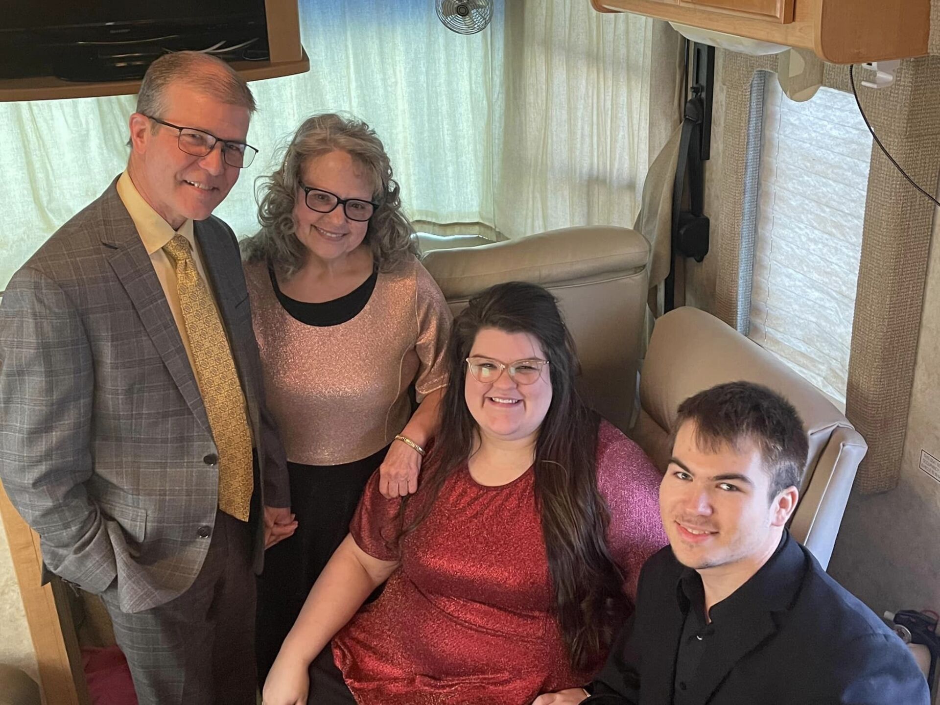A family is posing for a picture in a rv.