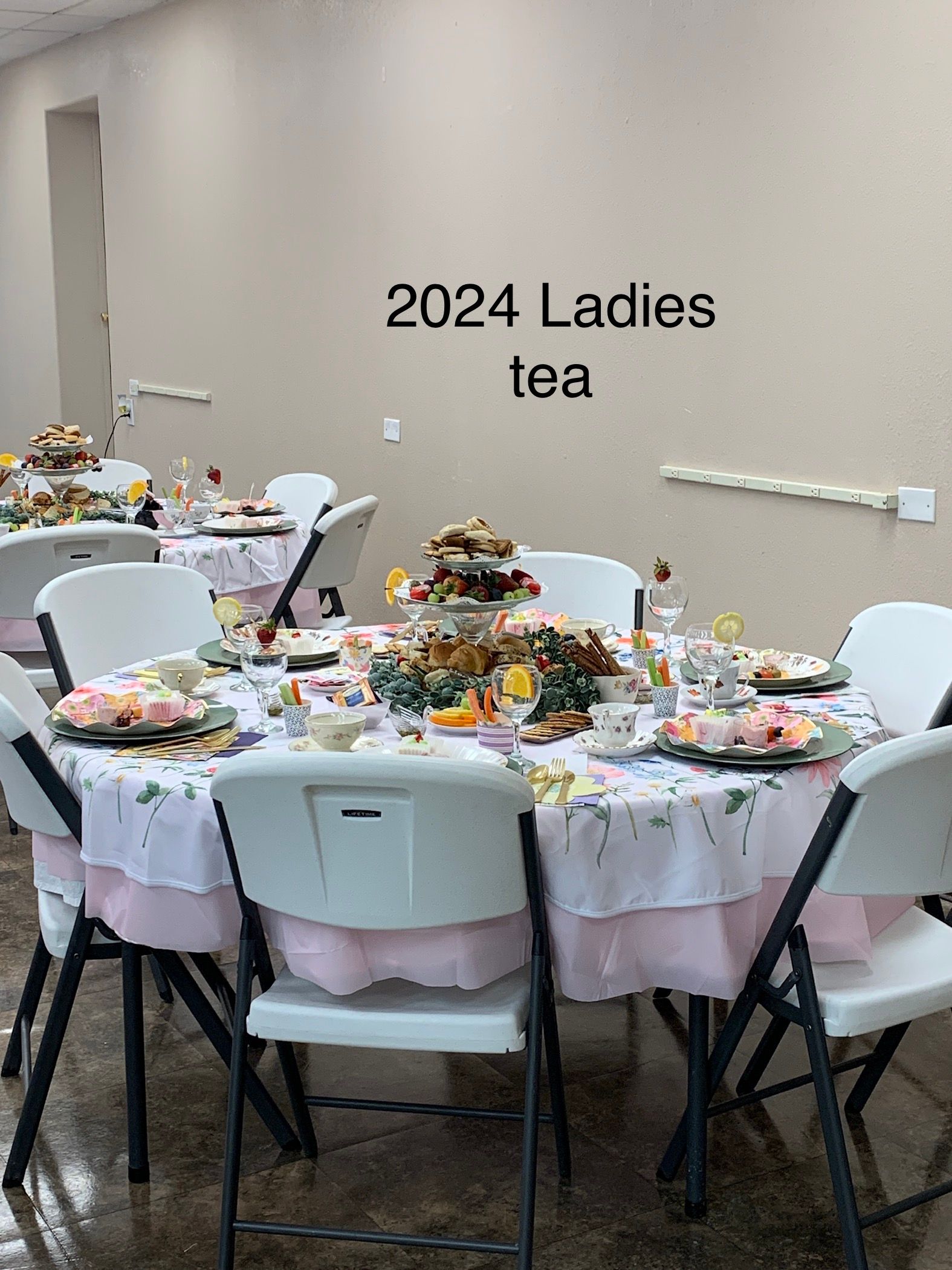 A room with tables and chairs set up for 2024 ladies tea