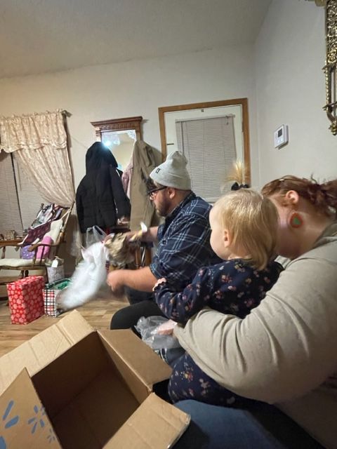 A woman is holding a baby in her lap in a living room