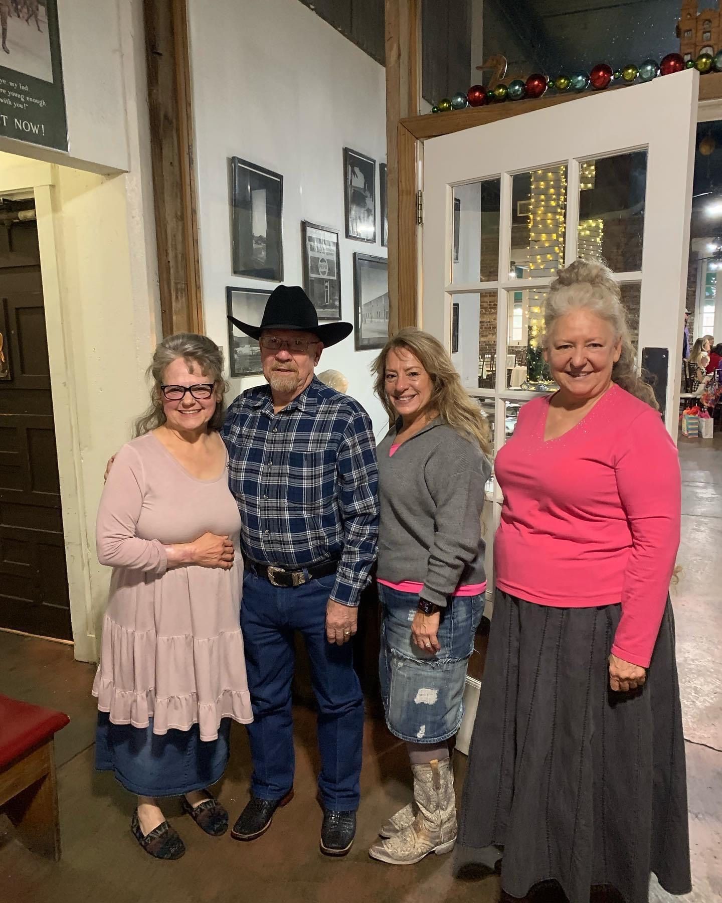 A group of people are posing for a picture in a room.