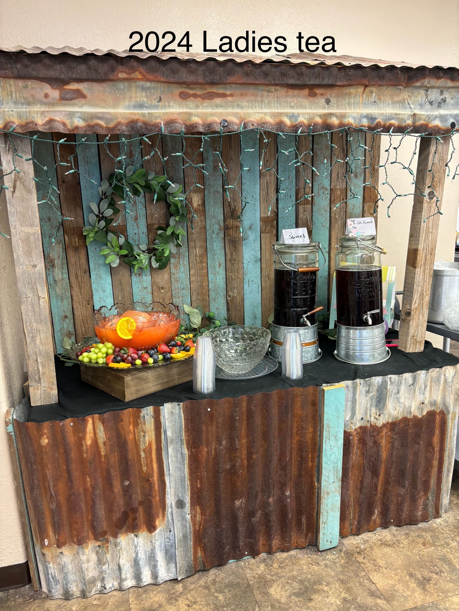 A wooden table with a sign that says 2024 ladies tea