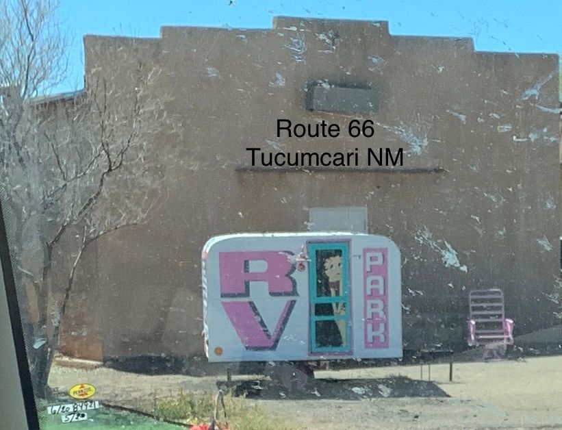 A sign that says route 66 tucumcari nm on it