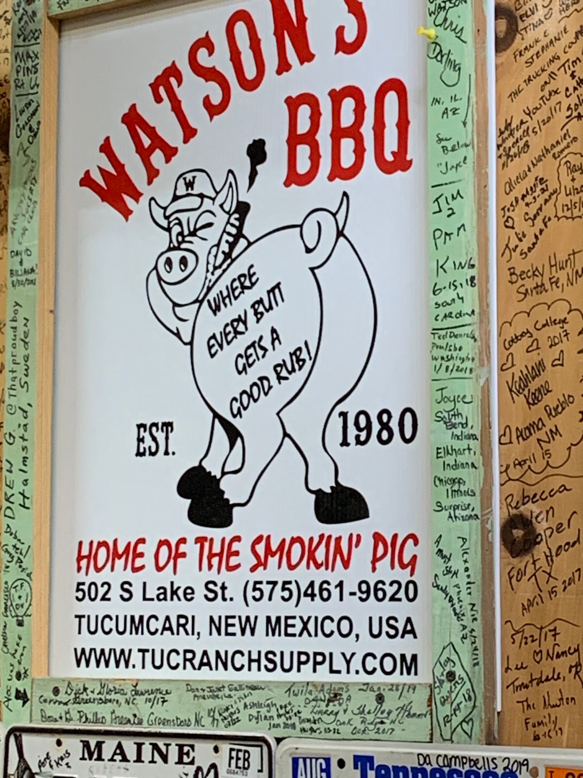 A sign for watson 's bbq has a picture of a pig on it