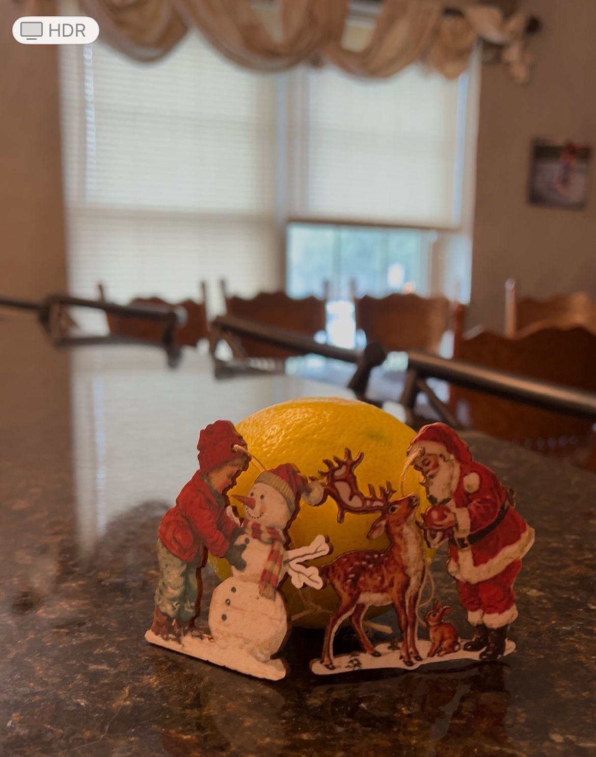 Lemon surrounded by wooden christmas ornaments