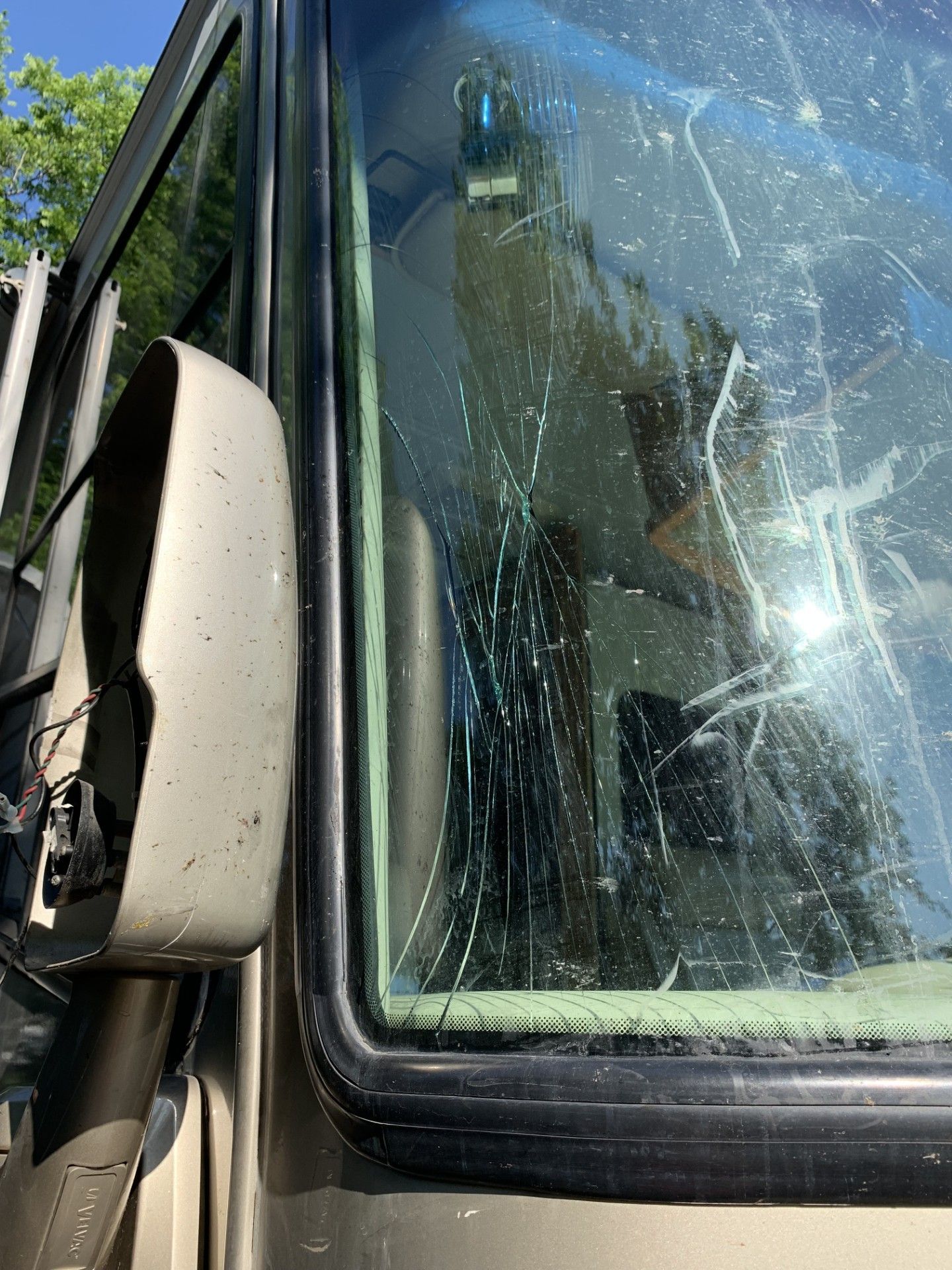 A close up of a broken windshield on a vehicle.