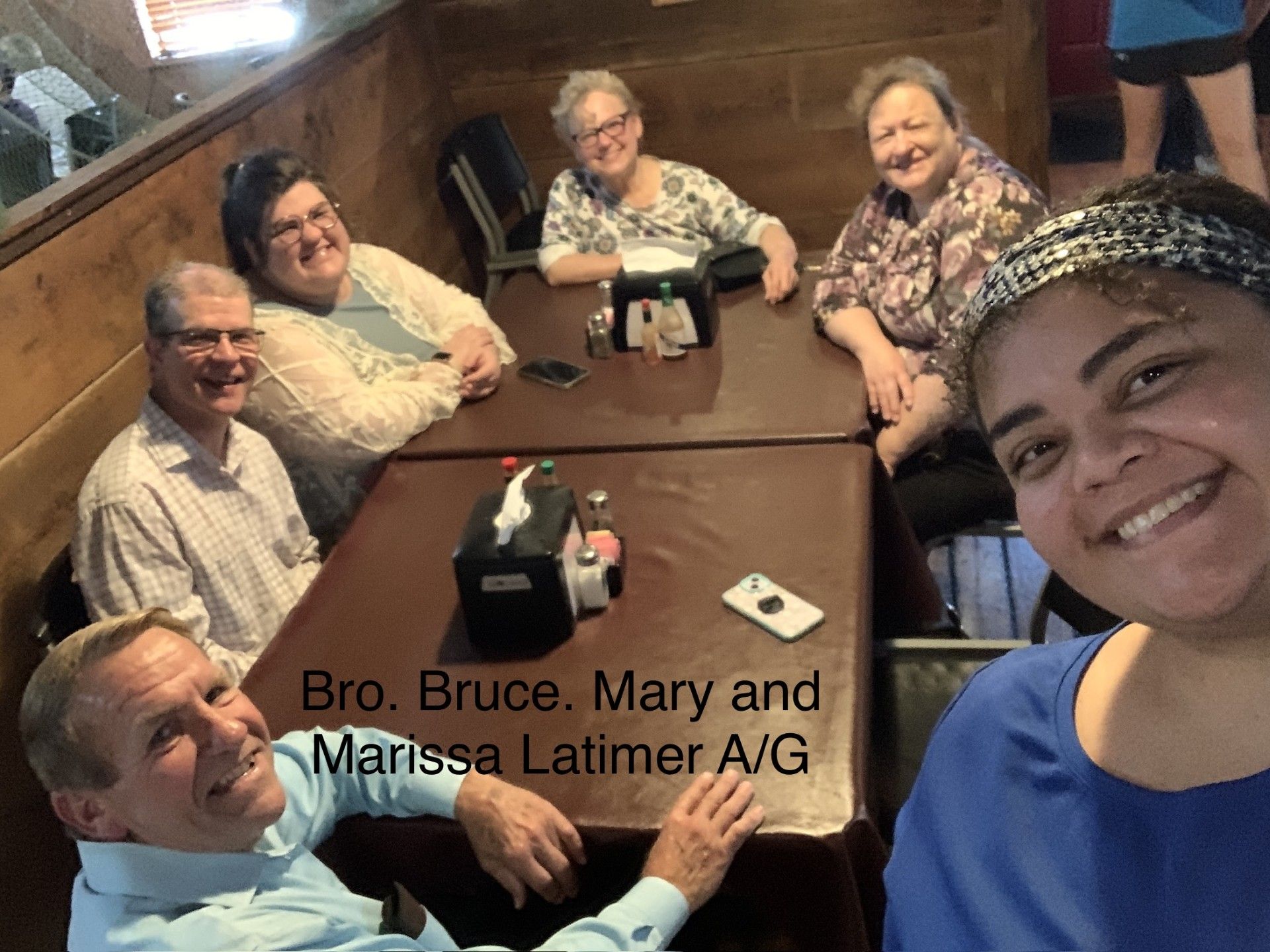 group gathered around a table where they had just paid the bill after eating