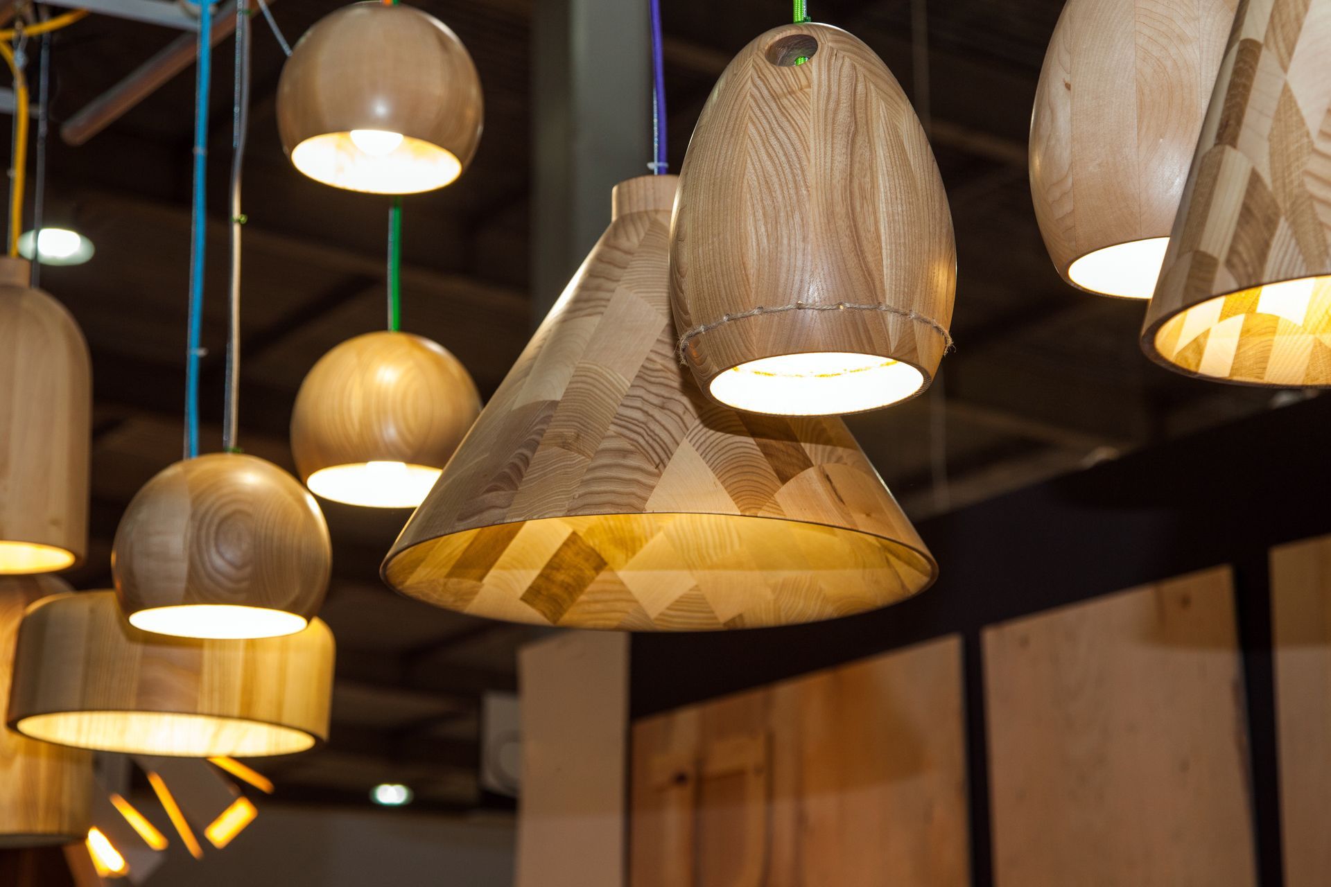 An array of sleek, wooden modern ceiling light fixtures suspended from the ceiling, casting a warm and inviting glow.