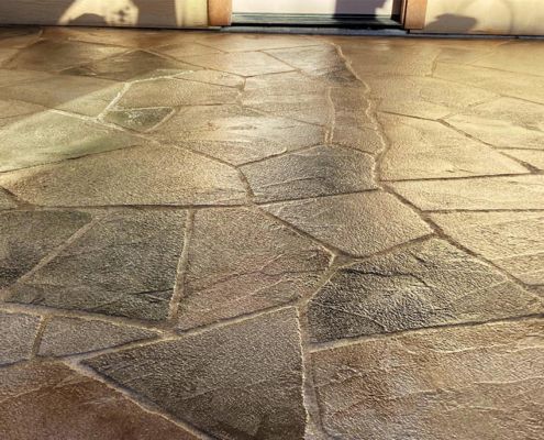 Decorative concrete flooring, flagstone pattern in shades of brown and gray.
