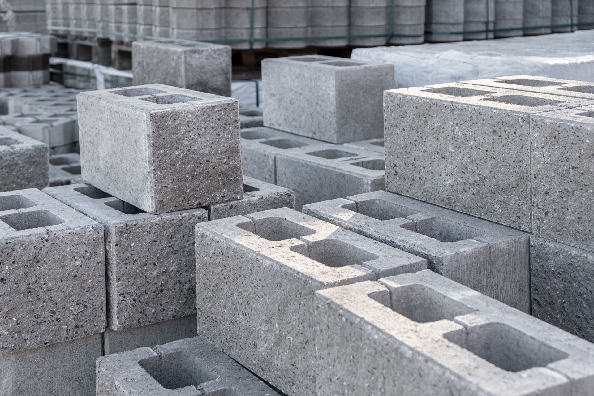 Gray concrete blocks stacked at a construction site.