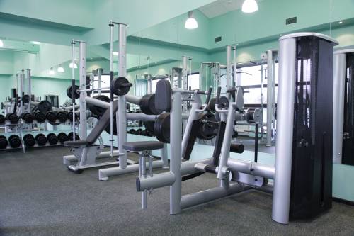 A gym filled with lots of exercise equipment and dumbbells