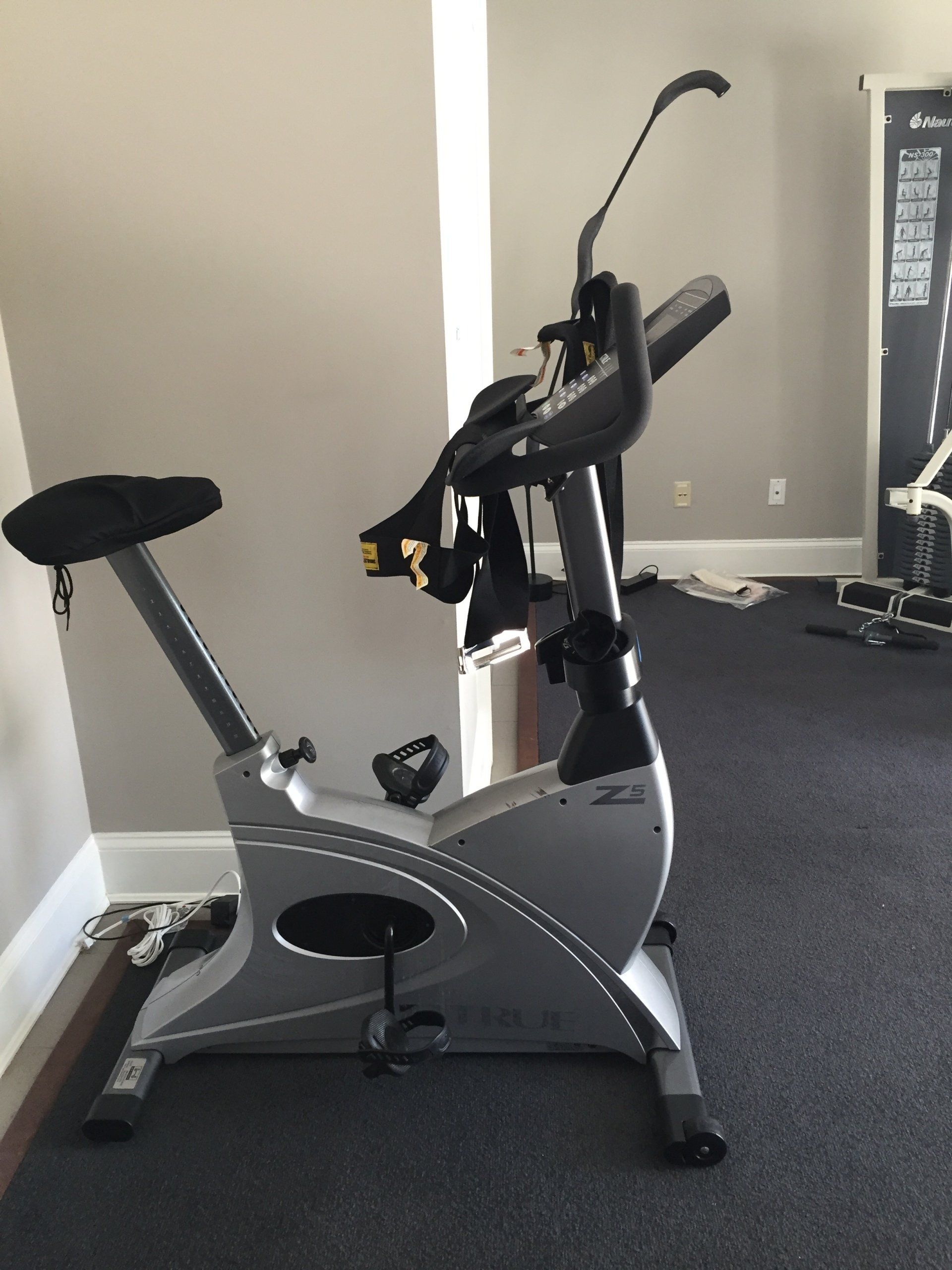 An exercise bike is sitting on the floor in a room