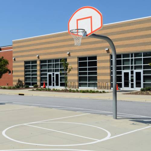 A basketball hoop is in front of a building