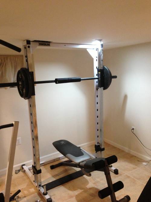 A squat rack with a barbell on top of it