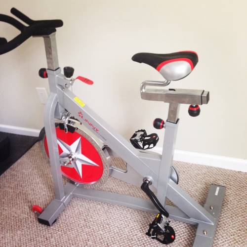 An exercise bike with a red star on the front wheel