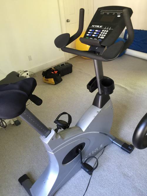 An exercise bike is sitting on the floor in a room