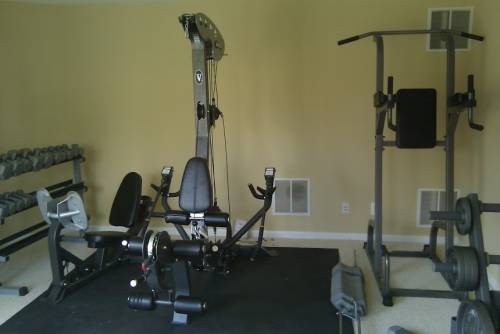 A multi station gym with a bunch of exercise equipment in it