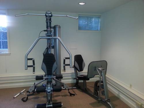 A gym with a machine that looks like a bike
