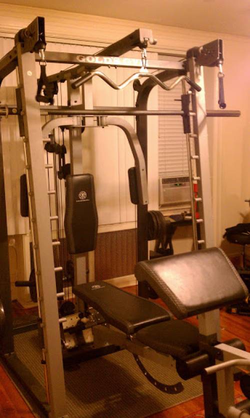 A Marcy weight cage gym with a lot of exercise equipment in it