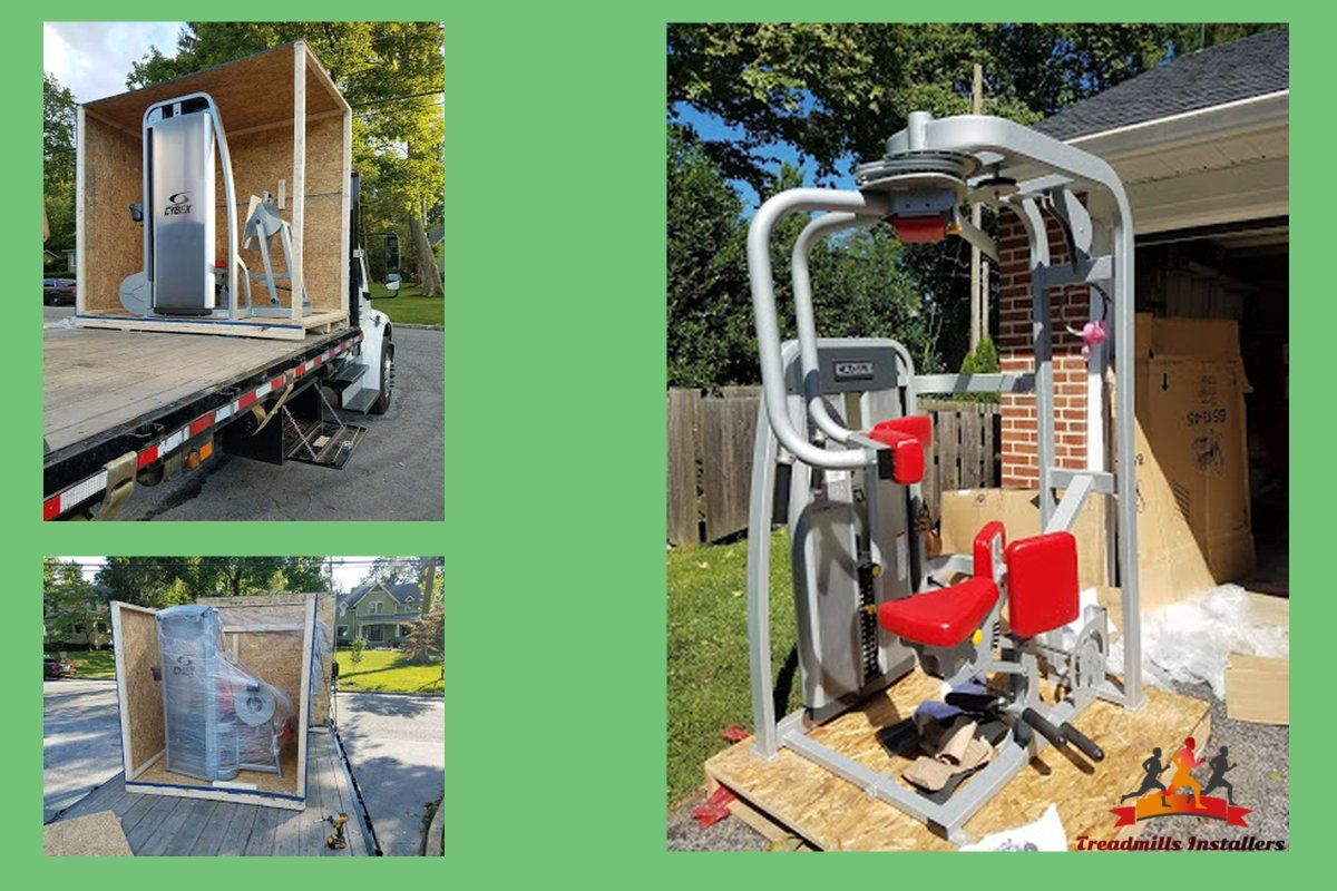 A machine is sitting on top of a wooden box on a trailer.