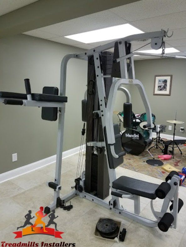 A treadmill is sitting in a room with a sign that says treadmills installers