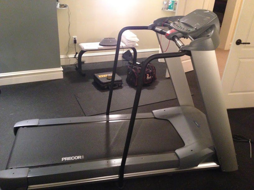 A treadmill is sitting in a room next to a mirror
