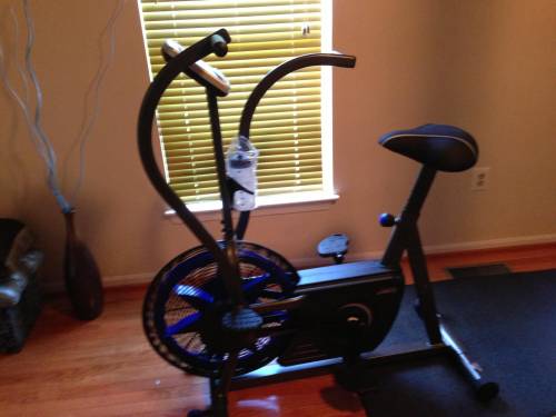 A black and blue exercise bike in a living room