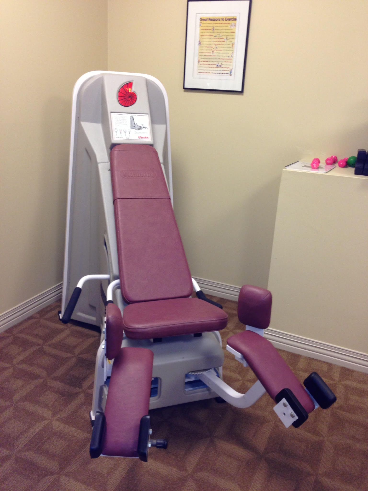 A red and white exercise machine in a room