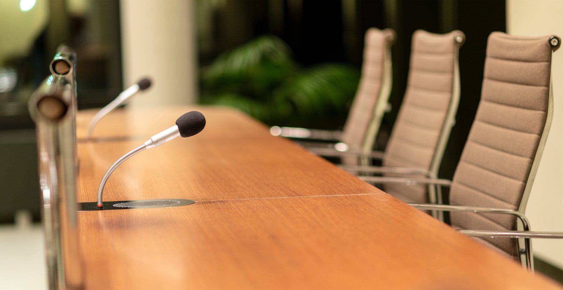 desks with microphones for a city council meeting live stream