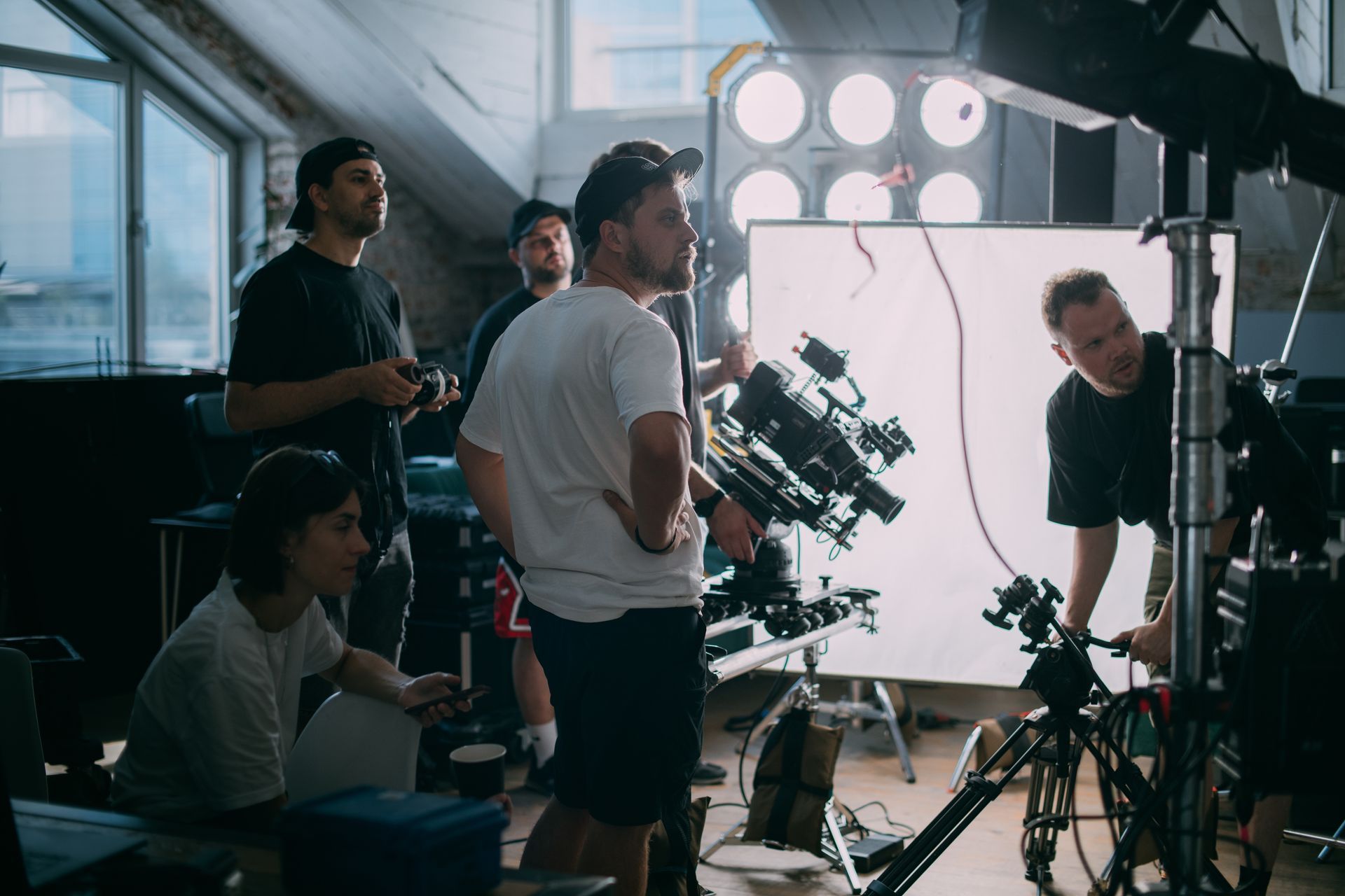 a group of directors and production assistants wait to begin shooting while discussing Film vs Video