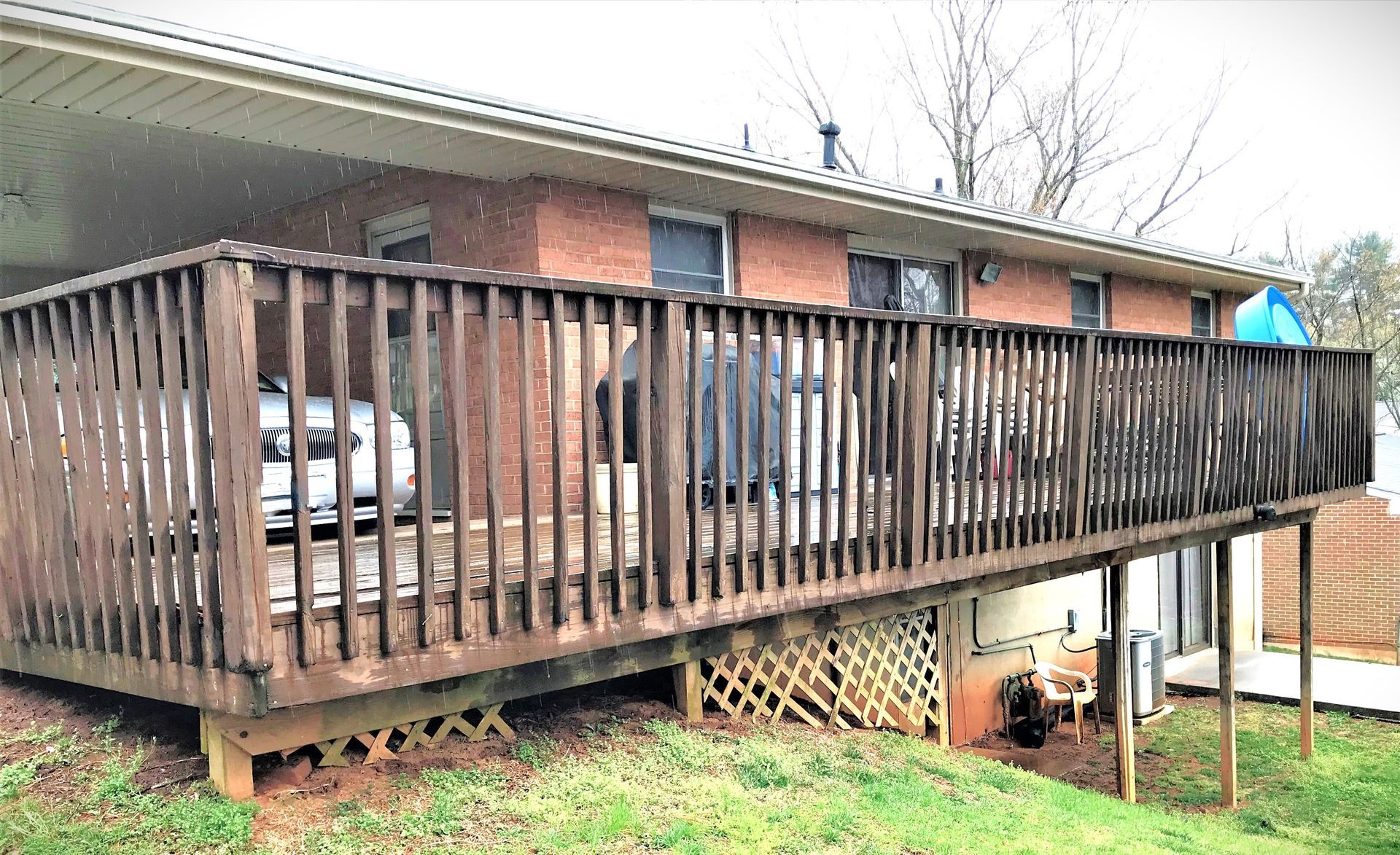 A Brick House With A Large Wooden Deck — Glade Hill, VA — Southern VA Construction