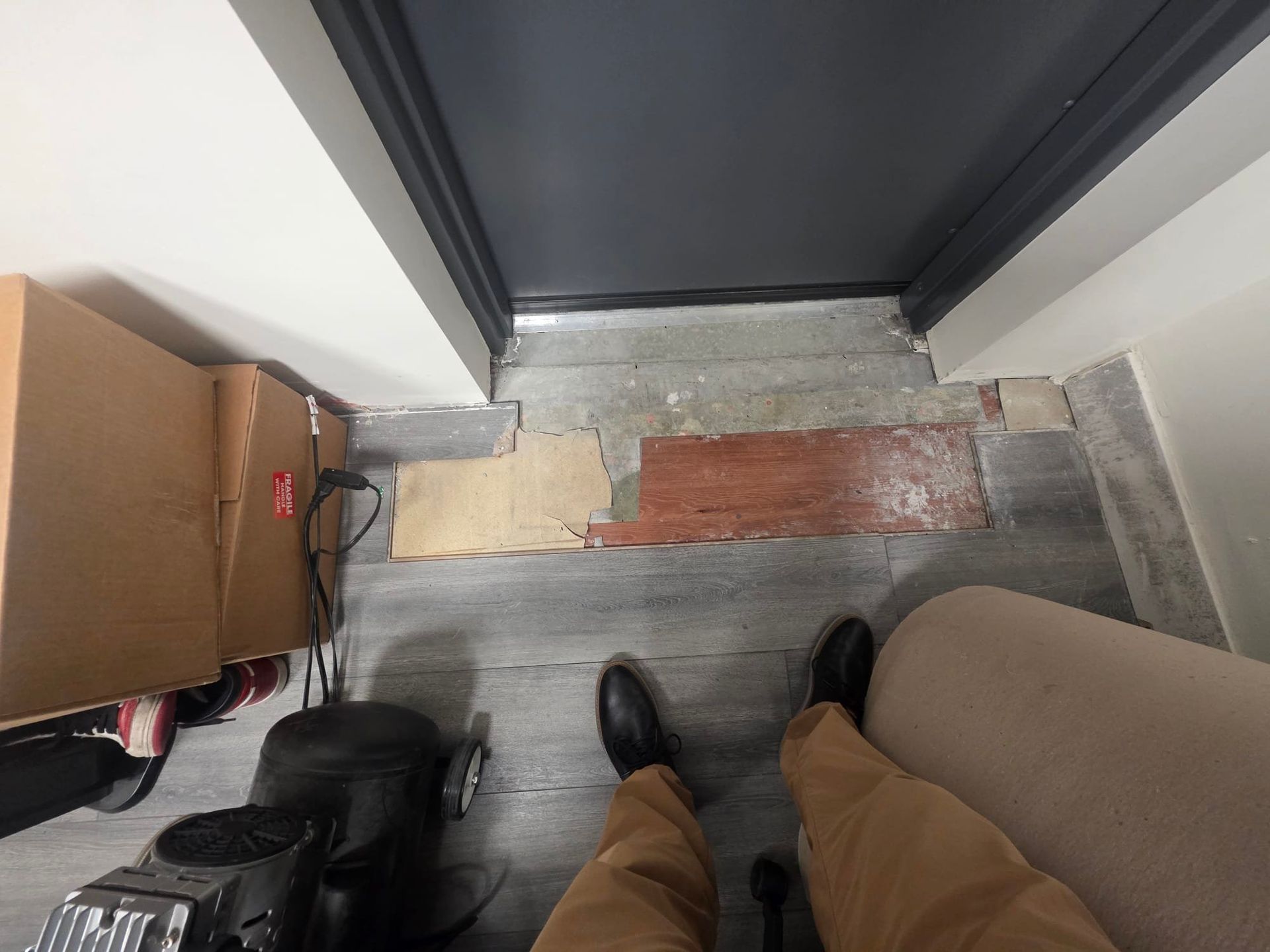 Concrete and brick retaining wall next to shopping carts and plants.