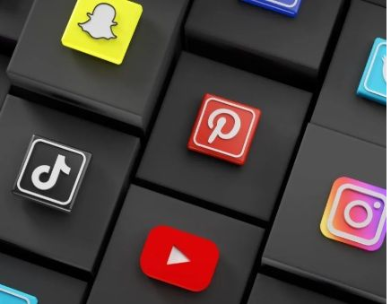 Social media icons (TikTok, Pinterest, Instagram, YouTube, Snapchat) on black cube background.
