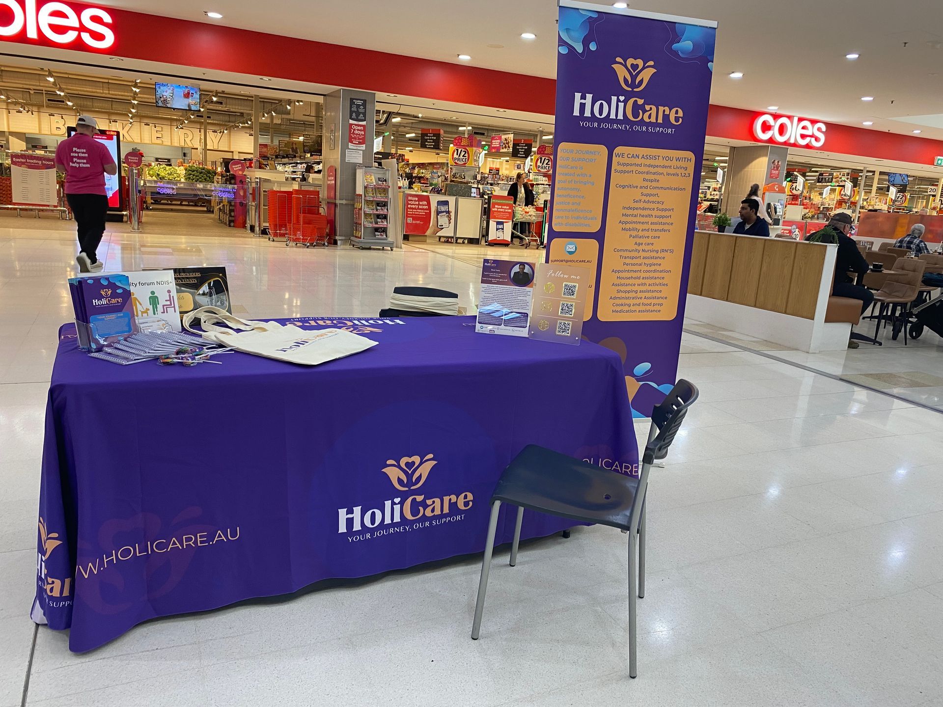 A purple table with a sign that says holicare on it