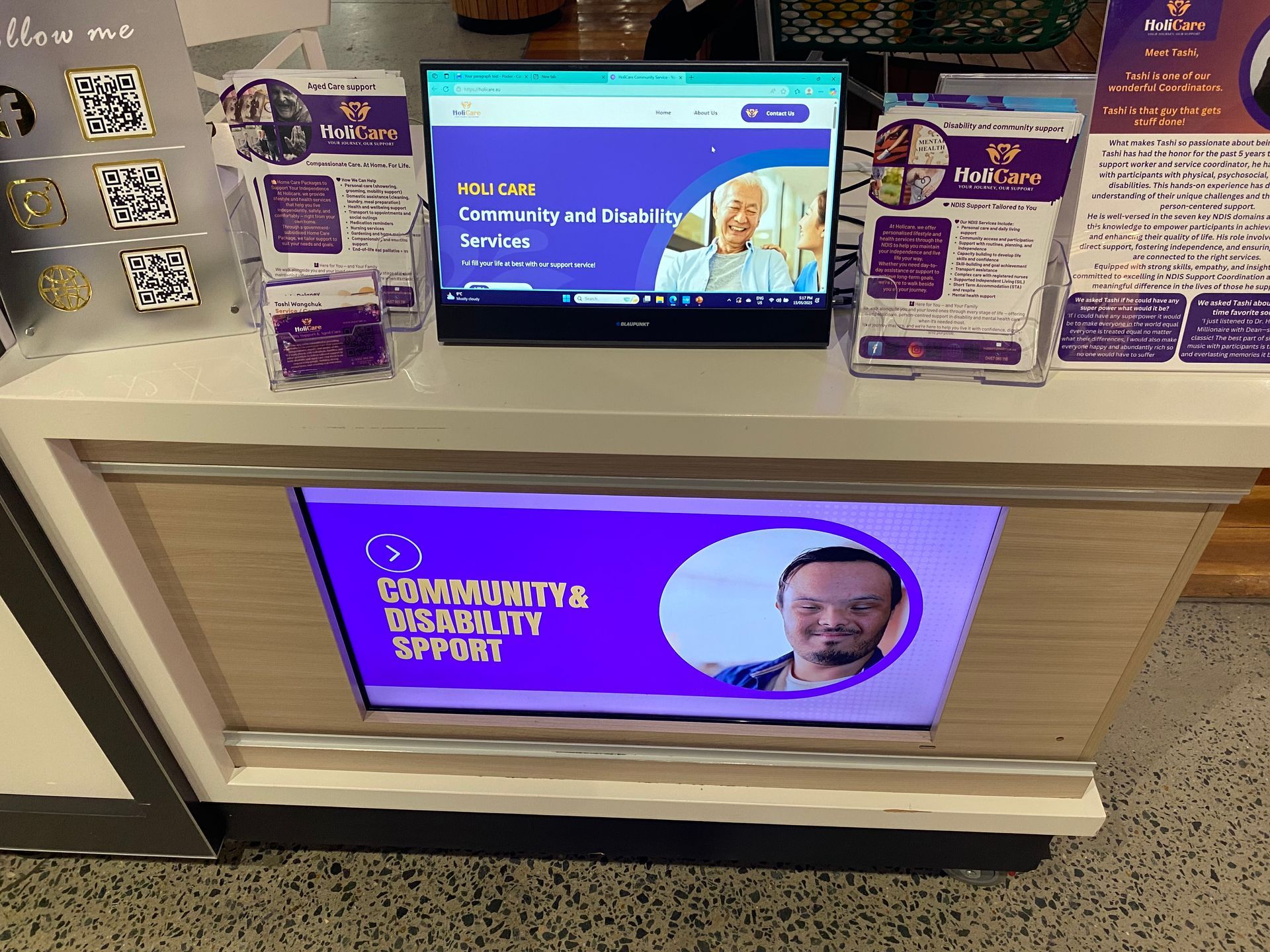 A computer monitor with a picture of a man on it is on a counter.