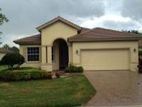 Front View House — Ivory Garage Door With Brown Paint Roof  in Myers, FL