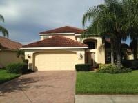 House With Three — Maroon Roof Paint and Yellow Paint Door Garage  in Myers, FL