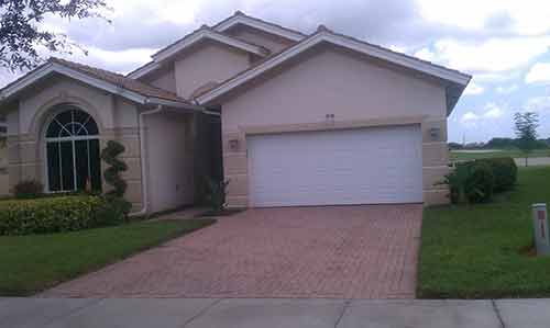 Driveways — White Garage Door and Windows in Front  in Myers, FL