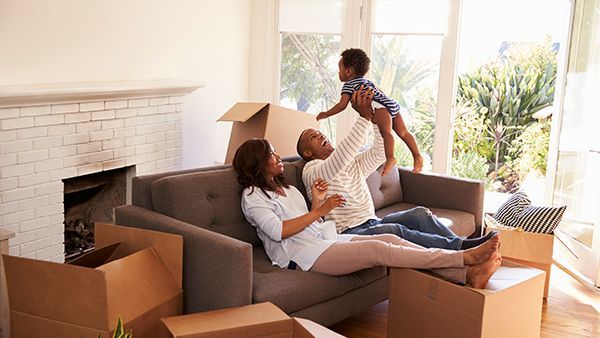 Couple and child on sofa in new home