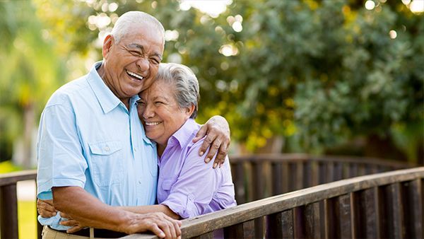 Senior couple hugging on porch