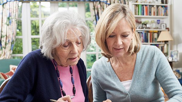 Mother and senior mother reviewing document