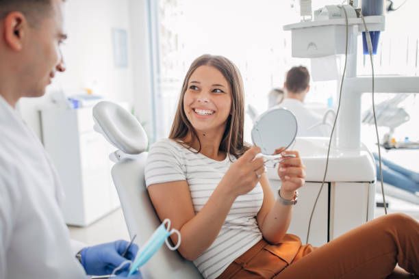 Charming woman at dentist, showcasing general dentist services for a healthy smile.