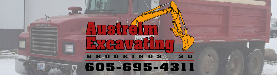 Red dump truck with the Austreim Excavating logo, Brookings, SD, and phone number 605-695-4311.