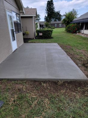 concrete backyard with fire place