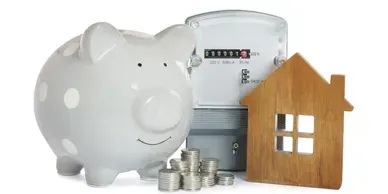 A piggy bank , a house , a meter and coins on a white background.