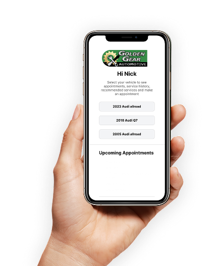 Hand holding a smartphone displaying an auto glass repair app. App shows options for 2023 and 2018 vehicles. | Golden Gear Automotive